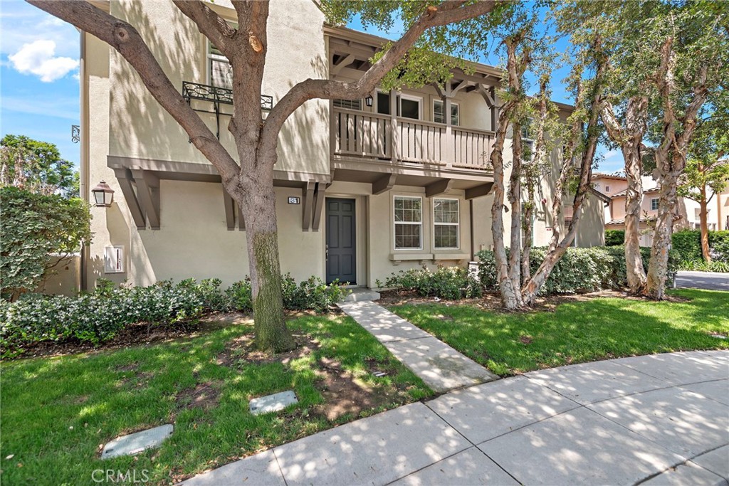 a view of a white house with a yard