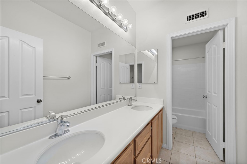 31 Notchbrook Lane Ladera Ranch, CA 92694 - Photo 22 of 24 a bathroom with a sink a vanity and a mirror