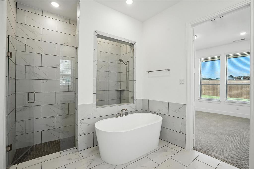 4621 Mount Vista Road Oak Point, TX 75068 - Photo 22 of 40 a bathroom with a bathtub and shower