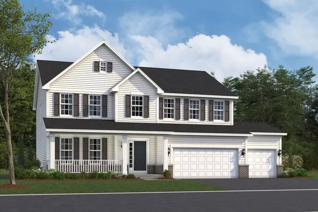 a view of a white house with large windows and a small yard