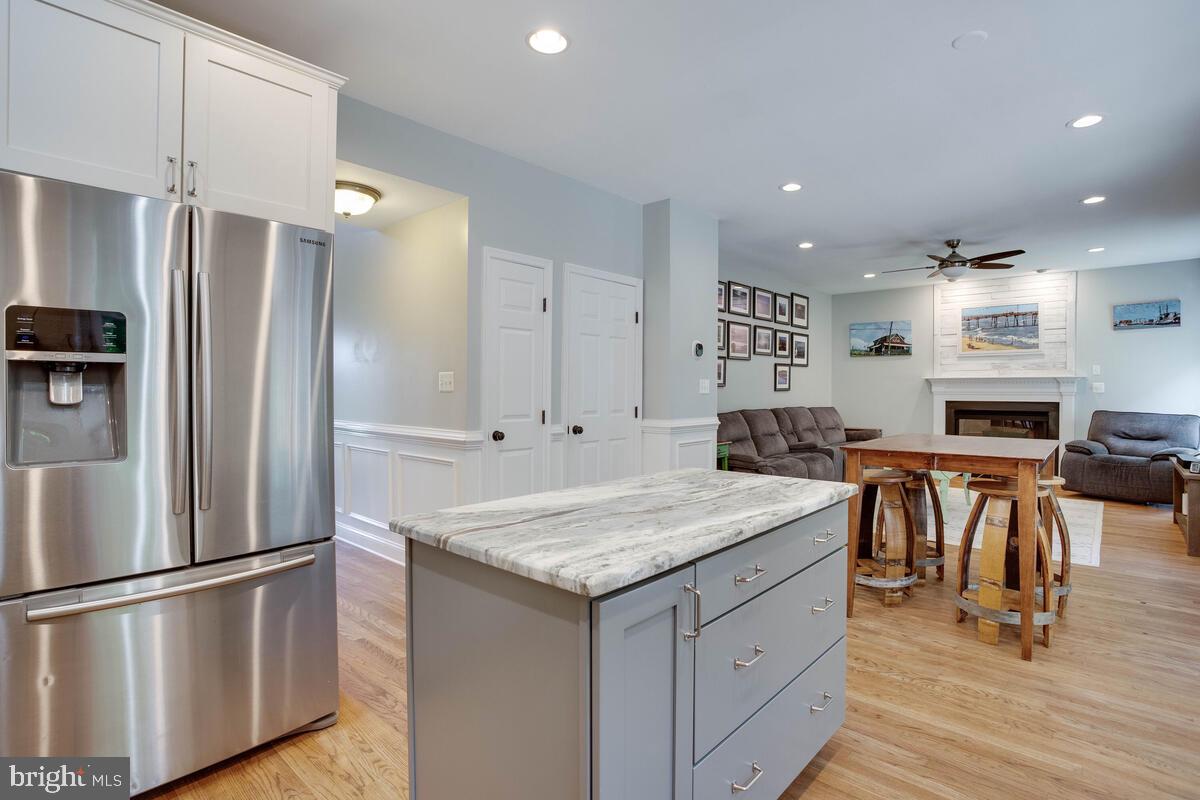 3369 Evans Road Huntingtown, MD 20639 - Photo 17 of 59 a kitchen with a refrigerator a sink and a stove top oven