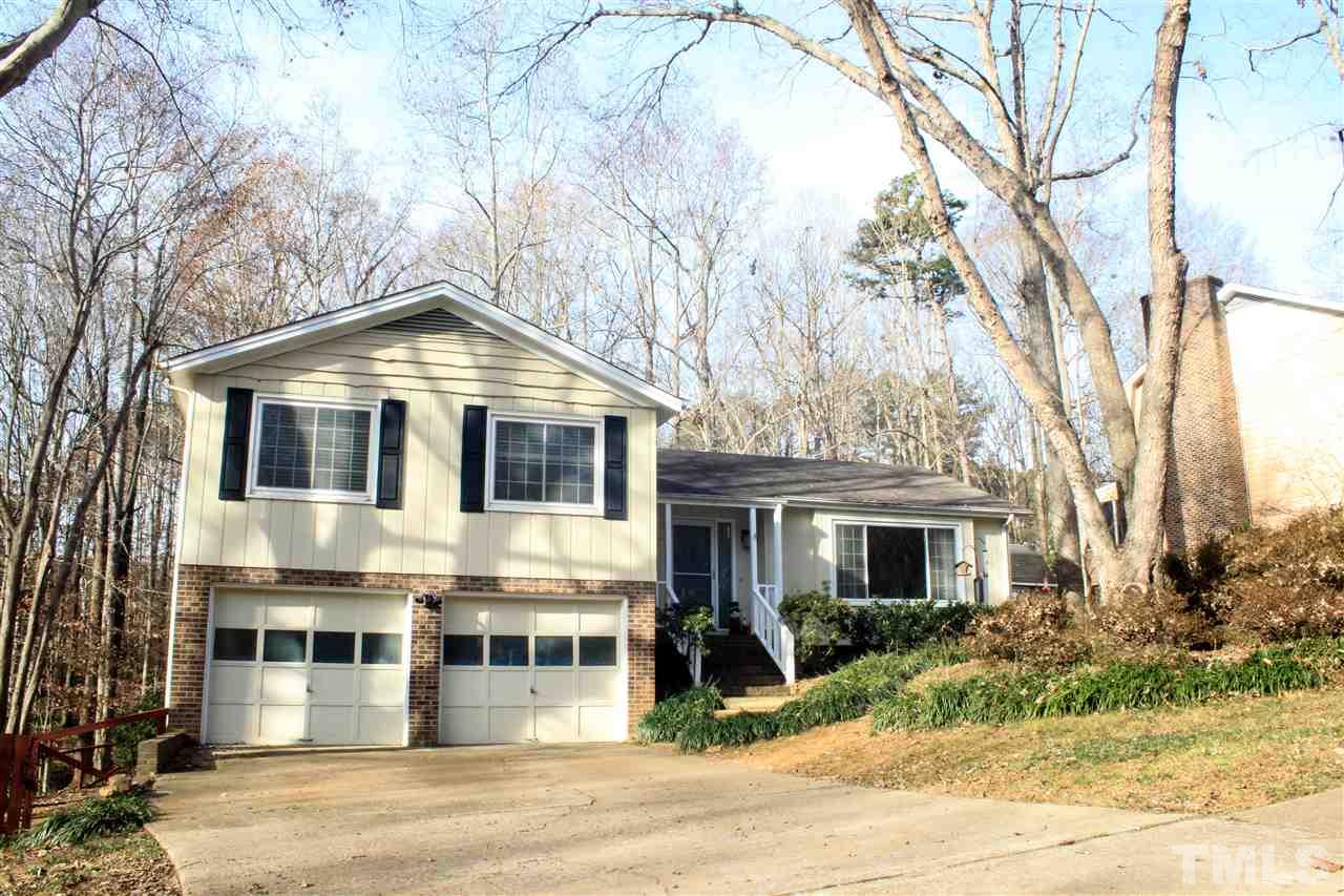 6401 Rushingbrook Drive Raleigh, NC 27612 - Photo 1 of 19 a view of a white house with a large tree and wooden fence