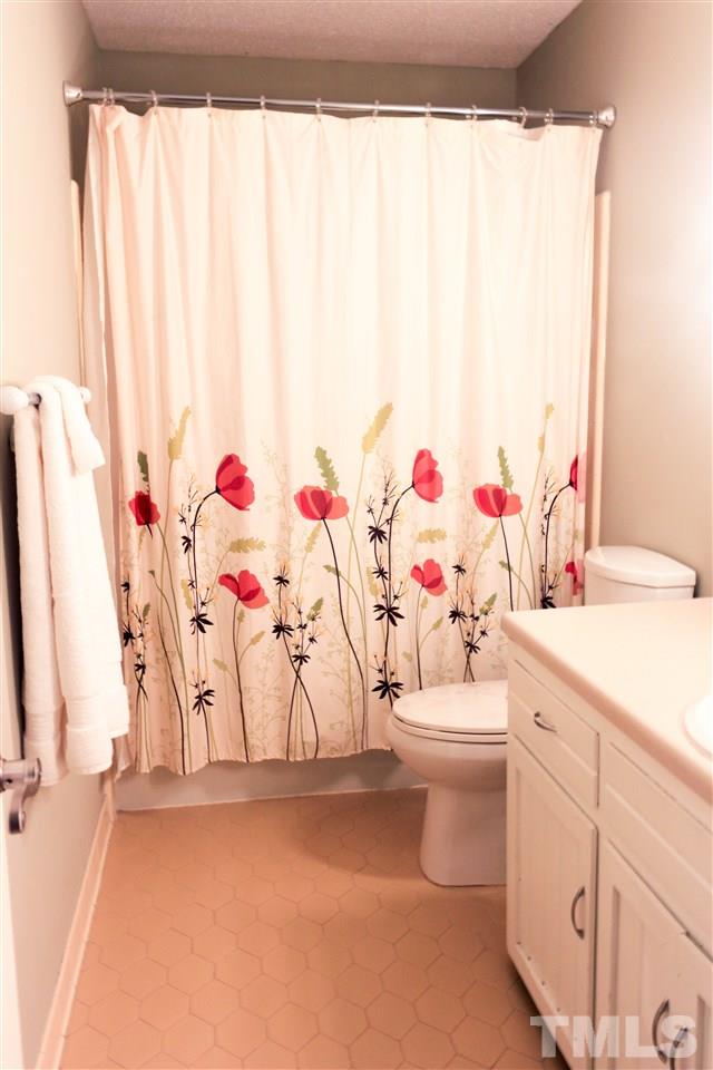 6401 Rushingbrook Drive Raleigh, NC 27612 - Photo 10 of 19 a bathroom with a sink mirror vanity and toilet