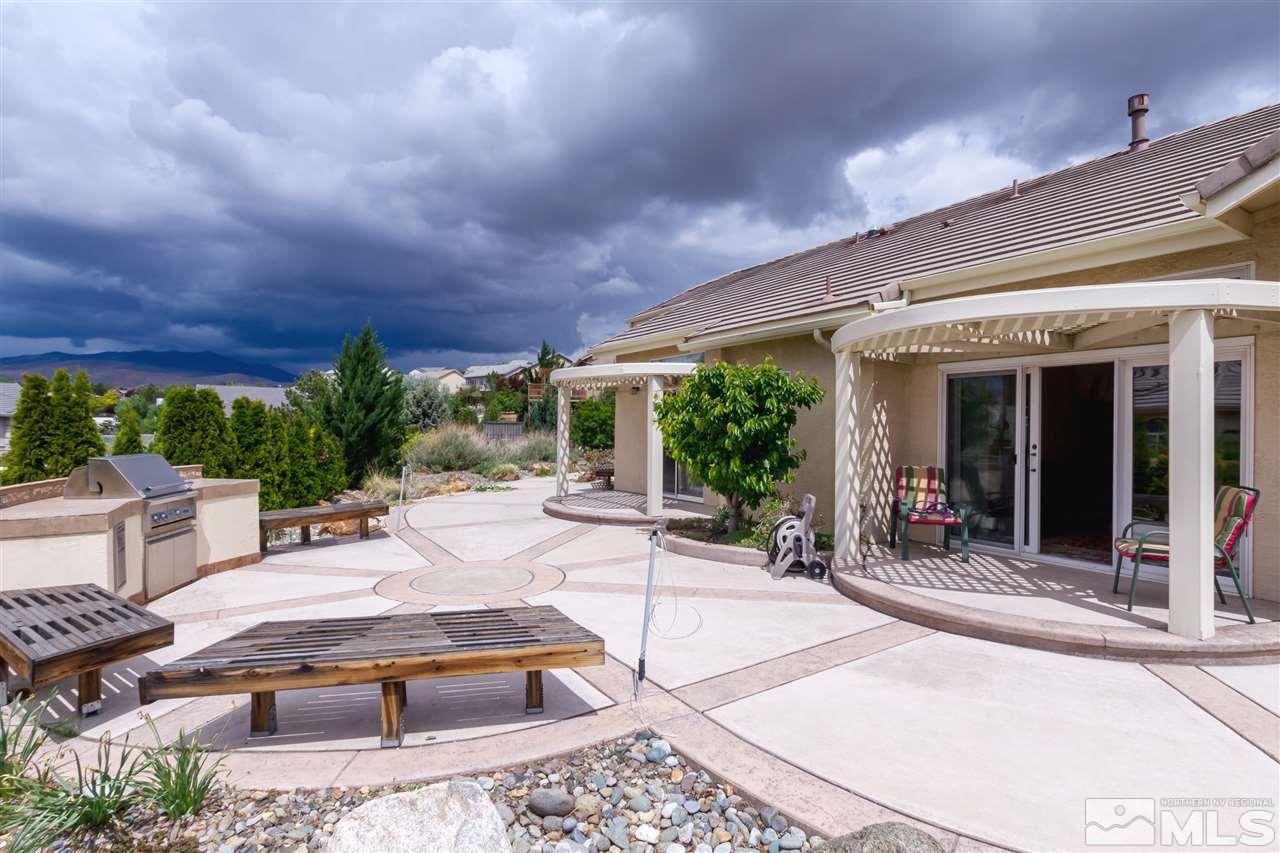 1104 University Ridge Drive Reno, NV 89512 - Photo 6 of 25 a building outdoor space with patio furniture and garden