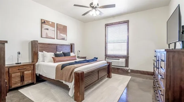 a bedroom with a bed and a chandelier