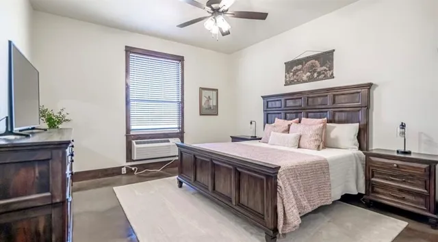 a bedroom with a bed dresser and a window