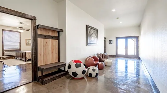 a bedroom with furniture and a large window