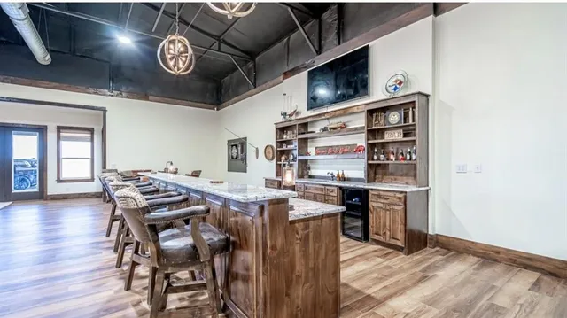 a view of a dining room with furniture and chandelier