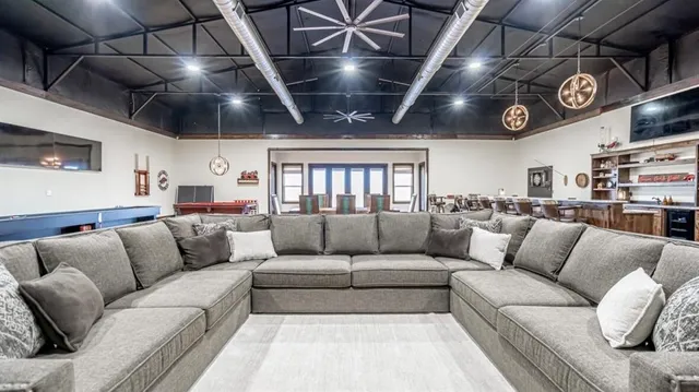 a living room with furniture and a chandelier