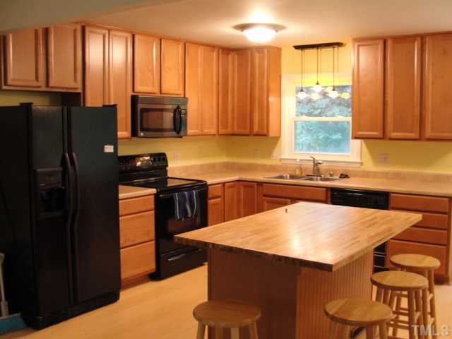 301 East Cornwall Road Cary, NC 27511 - Photo 3 of 25 Laminate flooring in the kitchen and adjacent flex room.