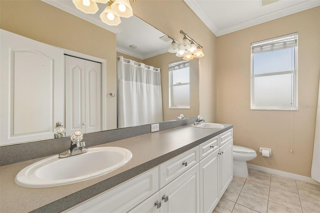 703 Bunker View Drive Apollo Beach, FL 33572 - Photo 26 of 49 a bathroom with a double vanity sink and a mirror