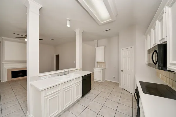 a kitchen with a cabinets and white appliances