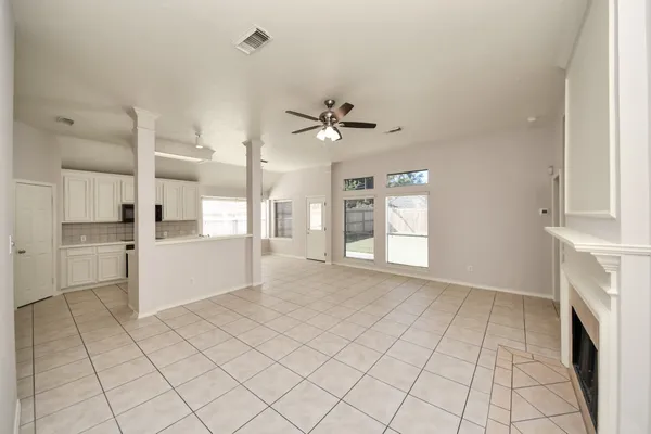 a view of an empty room with a kitchen