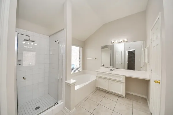 a large bathroom with a glass shower door a sink and a bathtub