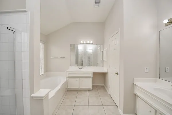 a bathroom with a sink a mirror and a bathtub