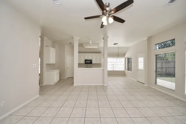 a large white kitchen with a sink and a refrigerator