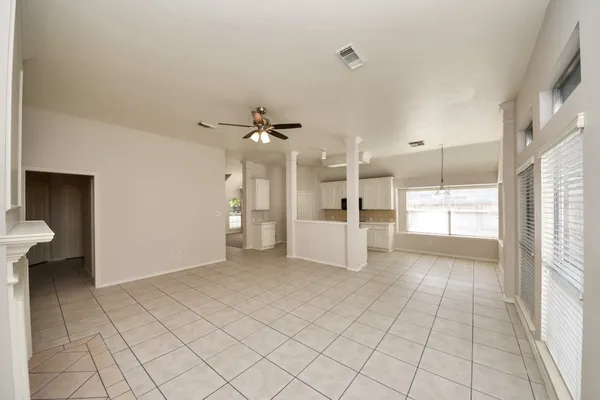 a view of a kitchen with furniture and an empty room