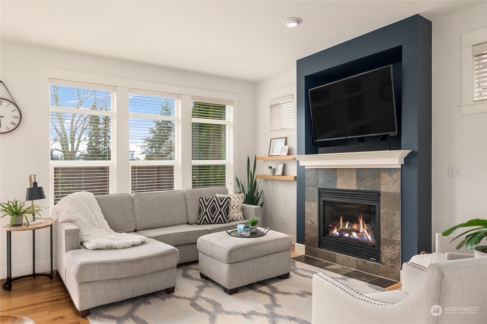 818 235th Place Southeast Bothell, WA 98021 - Photo 13 of 31 a living room with furniture a fireplace and a flat screen tv