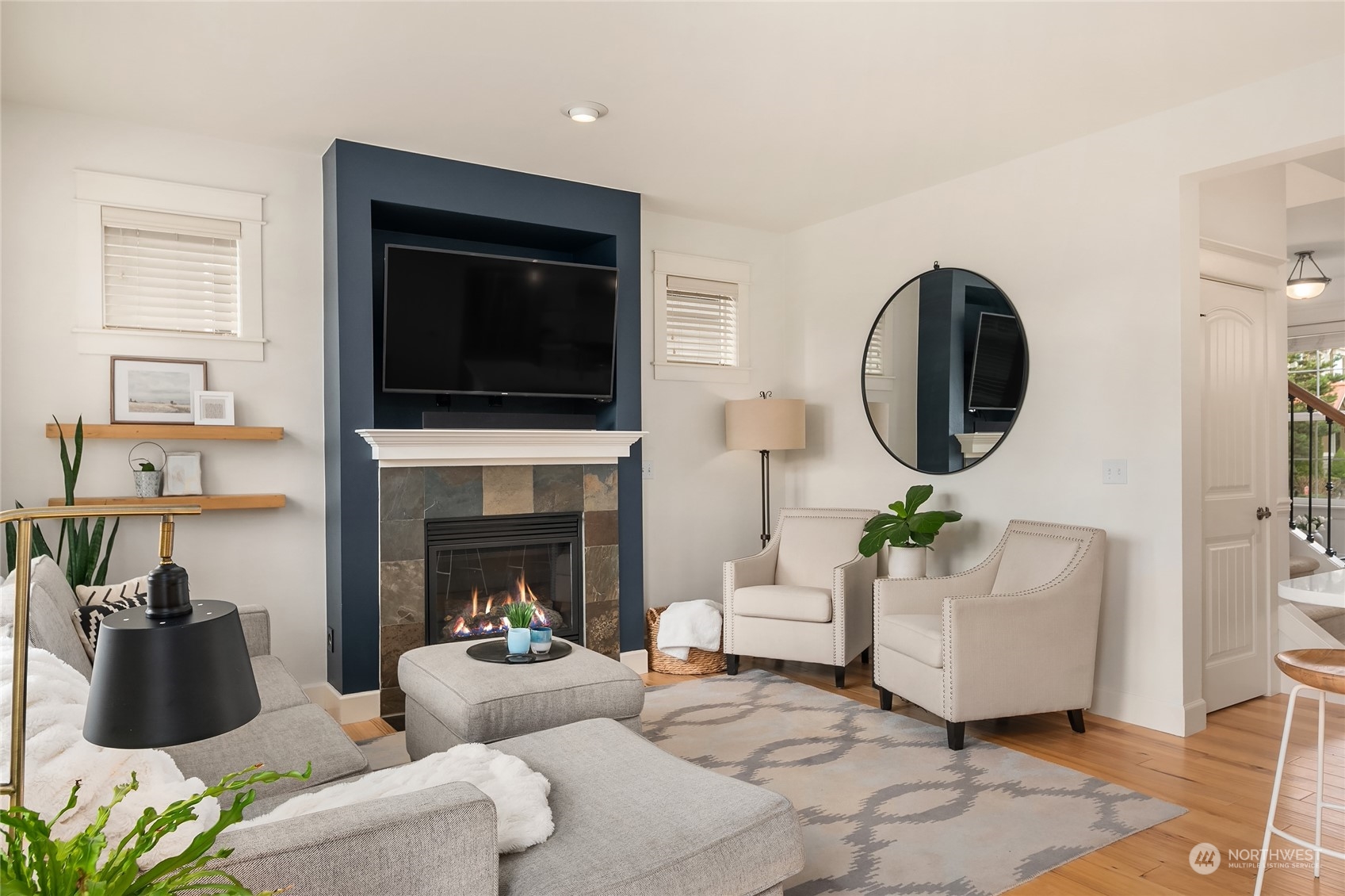 818 235th Place Southeast Bothell, WA 98021 - Photo 14 of 31 a living room with furniture a flat screen tv and a fireplace