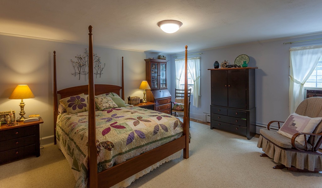 336 Mendall Road Acushnet, MA 02743 - Photo 23 of 30 a bedroom with a bed a lamp and a closet