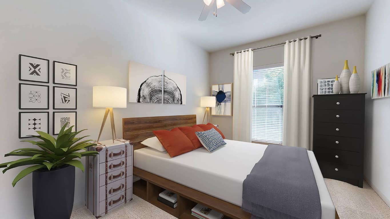 11400 Domain Drive, Unit 4117 Austin, TX 78758 - Photo 6 of 12 a bedroom with a bed and a potted plant