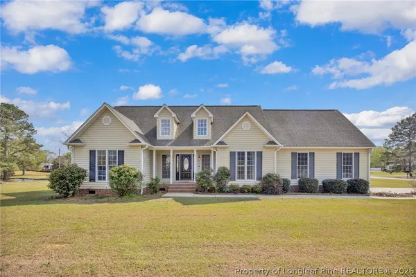 a view of a water fountain with tree in the background