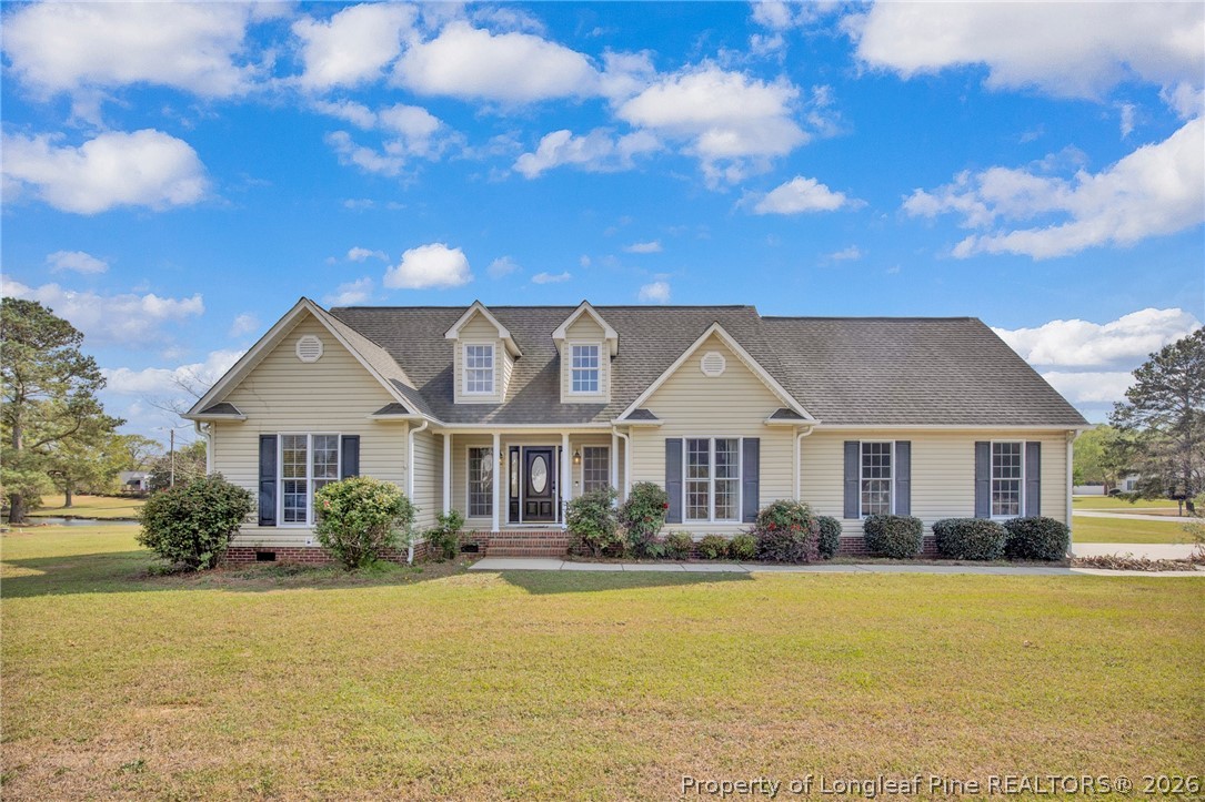 a front view of a house with swimming pool and porch