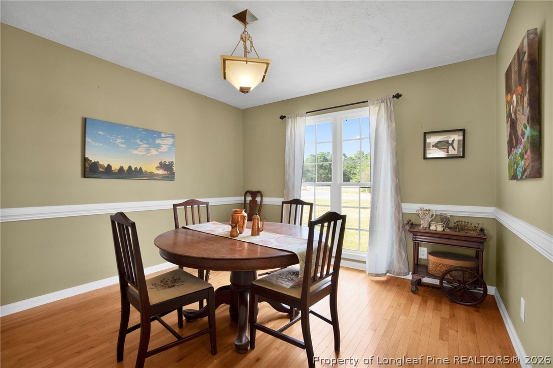 73 Timberlake Drive Clinton, NC 28328 - Photo 19 of 37 a view of a dining room with furniture and wooden floor