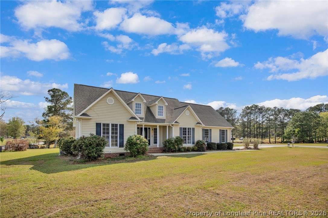 73 Timberlake Drive Clinton, NC 28328 - Photo 2 of 37 a front view of a house with a yard
