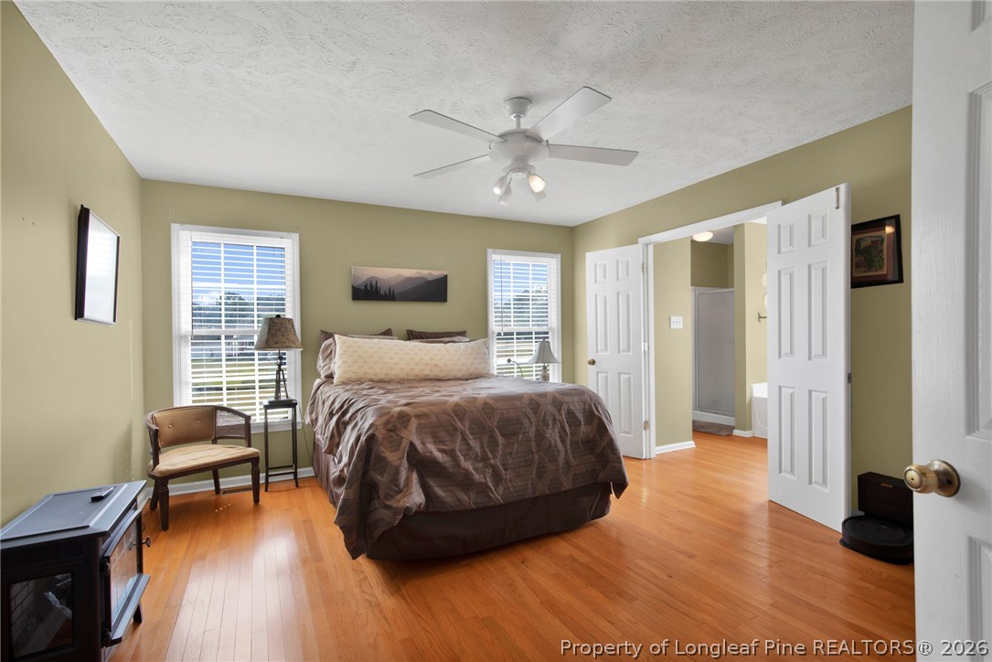 73 Timberlake Drive Clinton, NC 28328 - Photo 21 of 37 a bedroom with a bed and wooden floor
