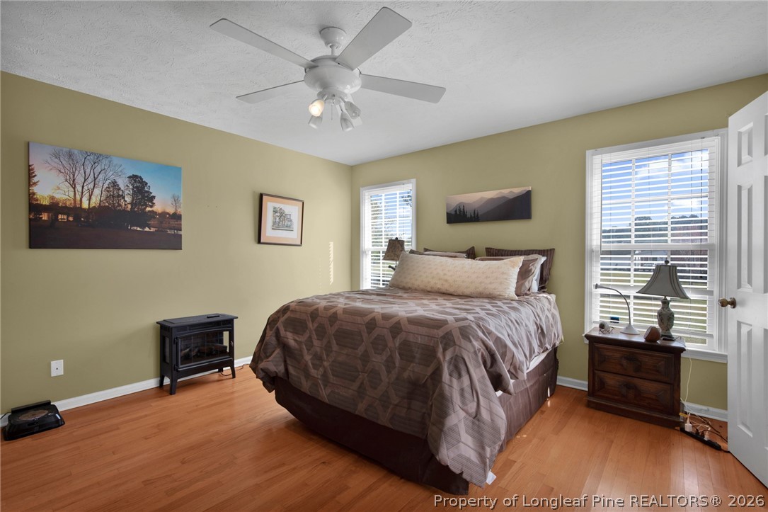 73 Timberlake Drive Clinton, NC 28328 - Photo 22 of 37 a spacious bedroom with a bed and a chandelier