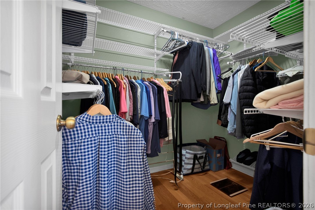 73 Timberlake Drive Clinton, NC 28328 - Photo 25 of 37 a view of walk in closet with clothes and shoes