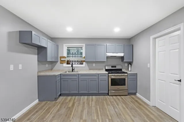 a kitchen with a sink stove and refrigerator