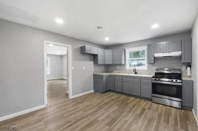a kitchen with a sink a refrigerator and window