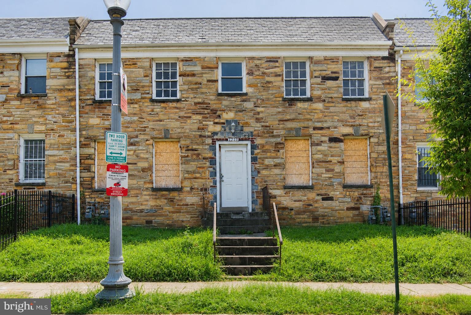 1219 Simms Place Northeast Washington, DC 20002 - Photo 1 of 7 Abandoned stone facade with boarded windows.