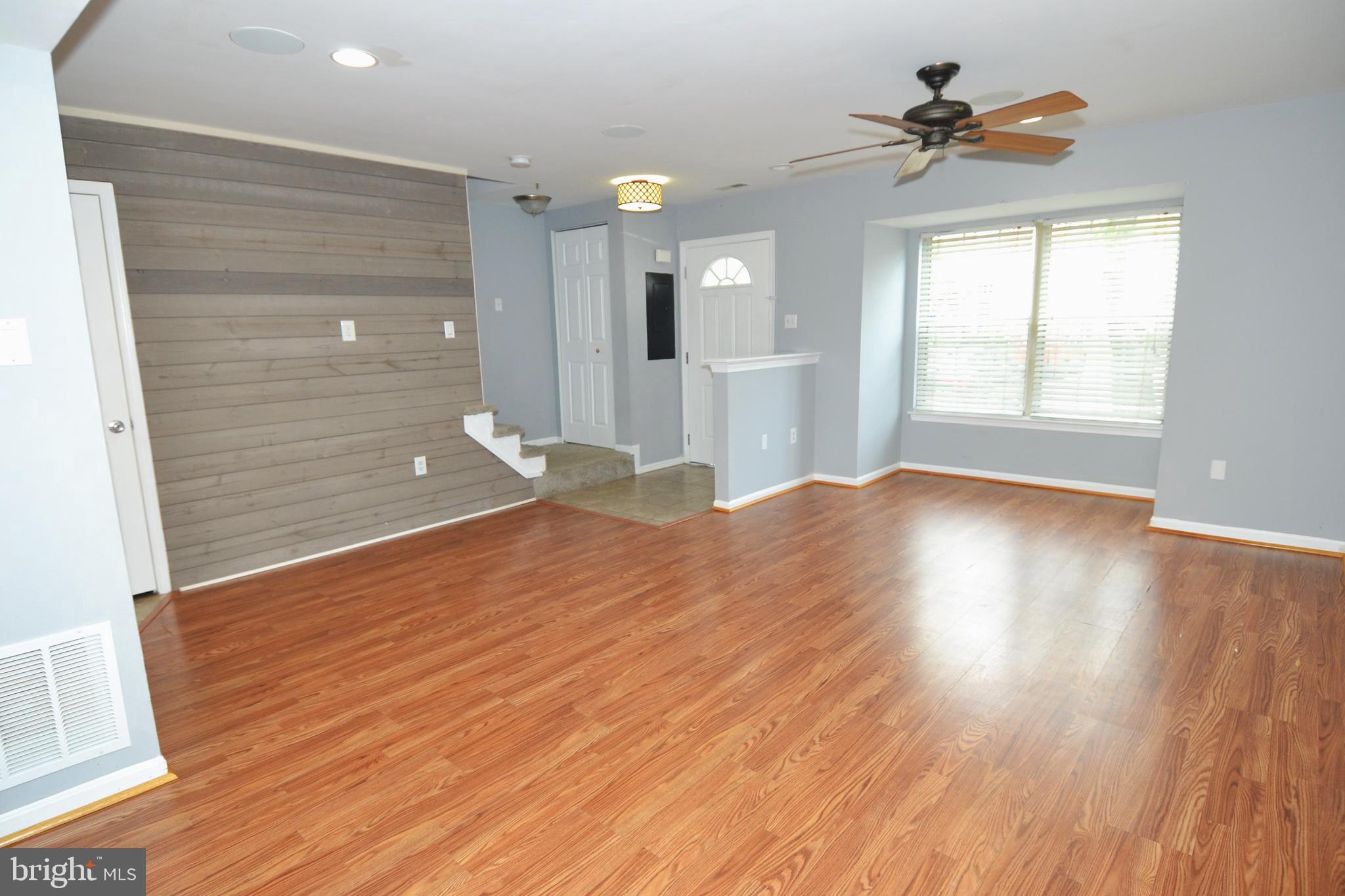 1465 Stoney Point Way Curtis Bay, MD 21226 - Photo 2 of 14 a view of empty room with wooden floor and fan