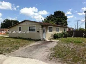 a view of a house with a backyard and garden
