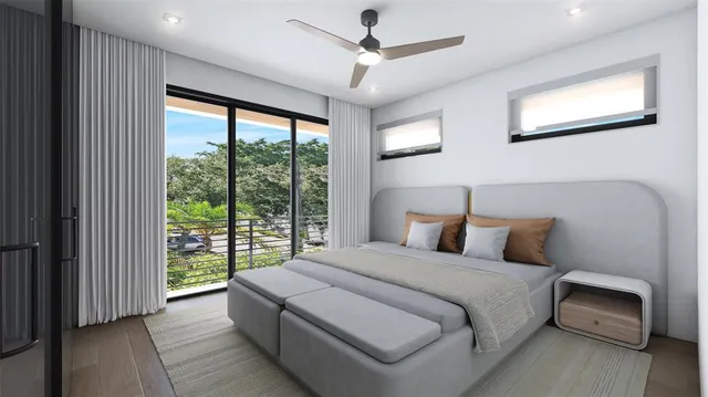 a bedroom with a large bed and a chandelier