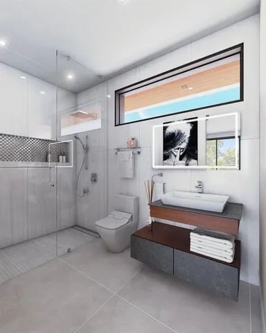 a spacious bathroom with a toilet a sink and mirror