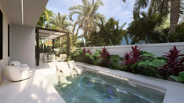 a aerial view of a house with a yard and potted plants