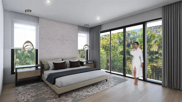 a bedroom with a bed and a large window