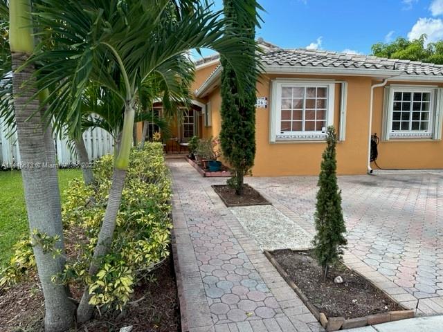 14636 Southwest 115th Terrace Miami, FL 33186 - Photo 1 of 12 a front view of a house with garden