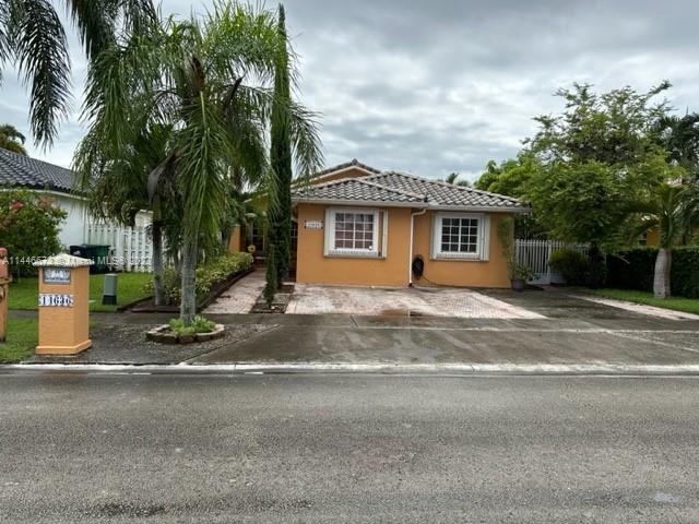 14636 Southwest 115th Terrace Miami, FL 33186 - Photo 4 of 12 a front view of a house with a garden