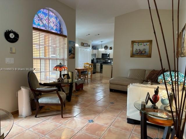 14636 Southwest 115th Terrace Miami, FL 33186 - Photo 5 of 12 a living room with furniture and a flat screen tv