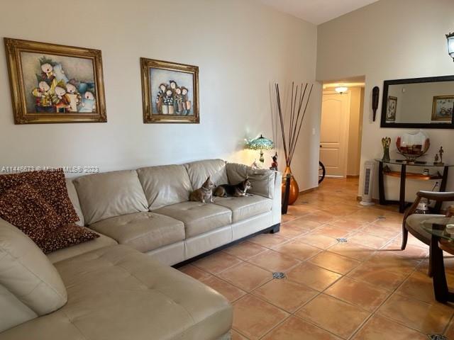 14636 Southwest 115th Terrace Miami, FL 33186 - Photo 6 of 12 a living room with furniture and a flat screen tv