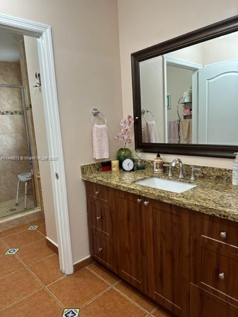 14636 Southwest 115th Terrace Miami, FL 33186 - Photo 9 of 12 a bathroom with a granite countertop sink and a mirror