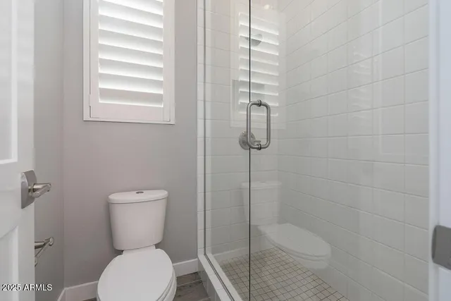 a white toilet sitting next to a bathroom sink