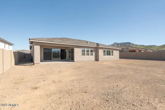 a view of house with a yard and mountain view