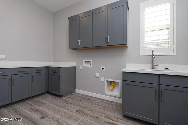 a kitchen with a sink cabinets and a window