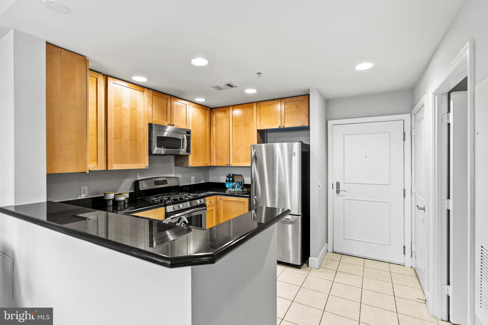 3600 South Glebe Road, Unit 605W Arlington, VA 22202 - Photo 5 of 36 a kitchen with stainless steel appliances granite countertop a refrigerator a sink and a stove